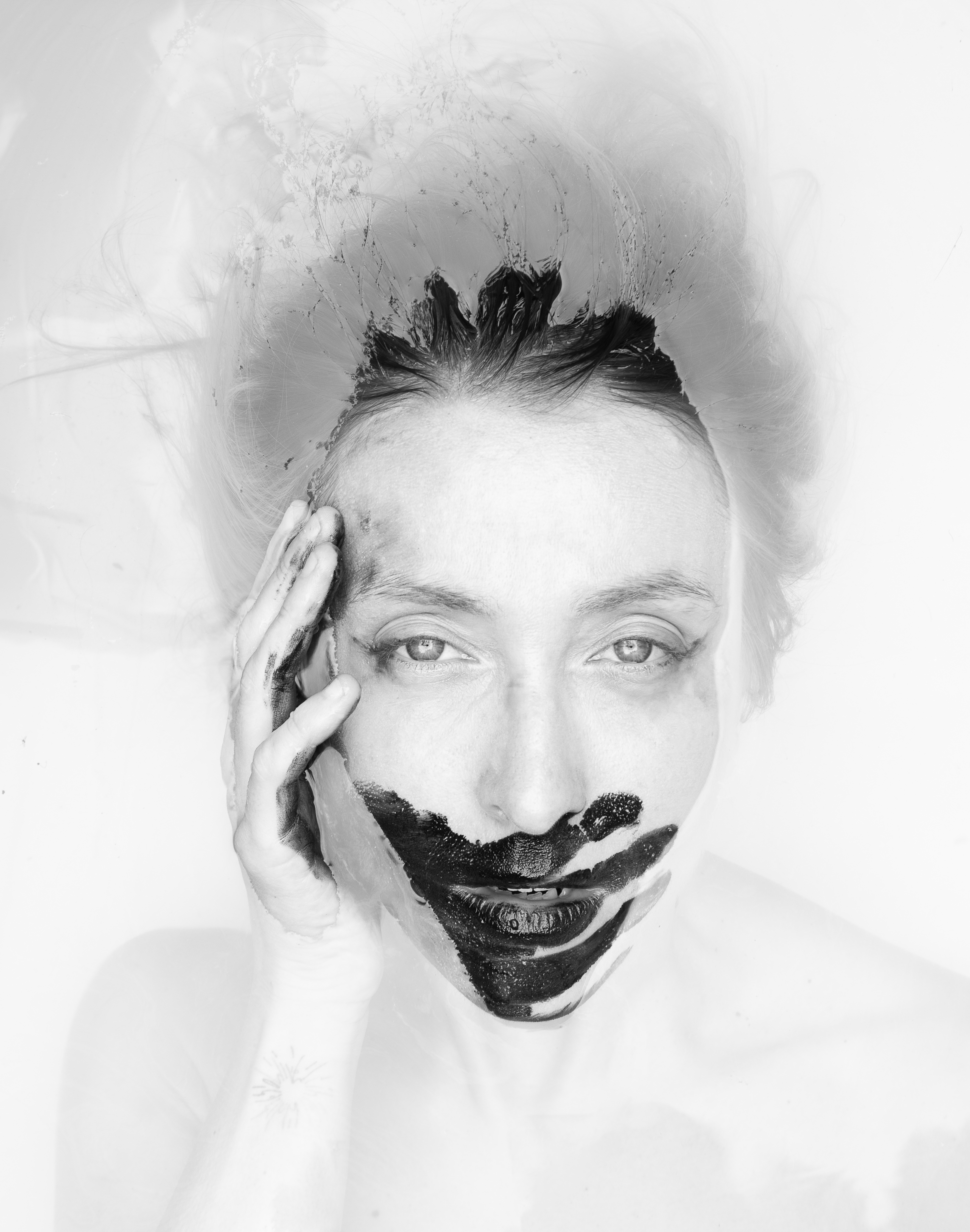 Held in the Blur portrait with water distorting the face